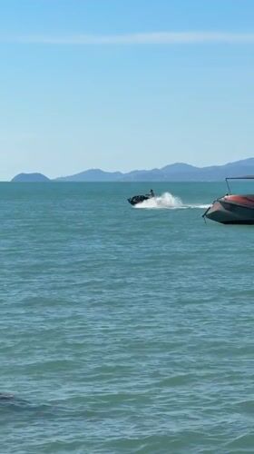 Jet skis and a boat launch on a sunny Koh Samui morning