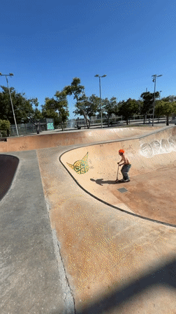 Scooter rider practices tricks at Barcelona skatepark