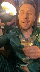 Man in green pajamas poses with champagne in Yekaterinburg