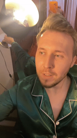 Man in green pajamas poses with champagne in Yekaterinburg