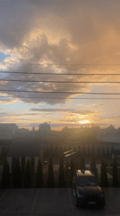 Golden-hour sunset across Novi Petrivtsi streets and rooftops