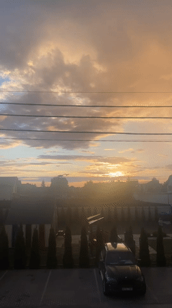Golden-hour sunset across Novi Petrivtsi streets and rooftops