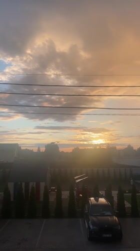 Golden-hour sunset across Novi Petrivtsi streets and rooftops