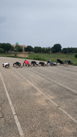 Group performs synchronized push-ups on Keffi running track