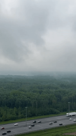 Morning highway traffic observed from above in Kudrovo, Russia