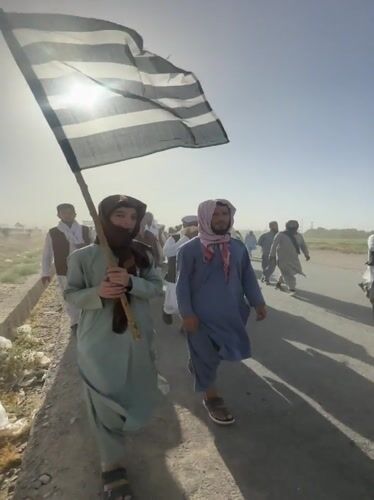 Men march in daytime procession in Pishin, Pakistan