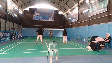 Badminton session in full swing at an indoor court in Aceh