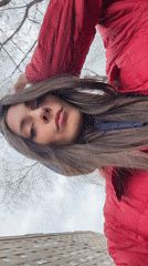 Woman takes selfies near cathedral in windy Krasnoyarsk morning