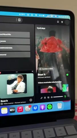 A laptop screen displays a Spotify interface. The left side shows a playlist titled "Mood Mood Mix" with song titles including "Simone" and "ARIMANDONA". The right side features a large video player showing Michael Jackson performing "Beat It". Below the video player, there is a smaller thumbnail of the same music video. The dock at the bottom of the screen shows icons for various applications including Apple TV, iTunes, Spotify, and Safari. The time is displayed as 10:16. The temperature is 25 degrees Celsius.