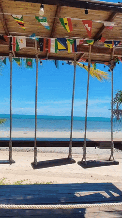 Thatched swings and banyan trees at a Thai beachside hangout