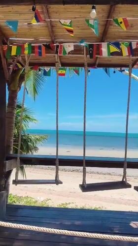 Thatched swings and banyan trees at a Thai beachside hangout