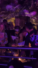 Milan outdoor club night glowing under purple and pink lights
