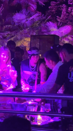 Milan outdoor club night glowing under purple and pink lights