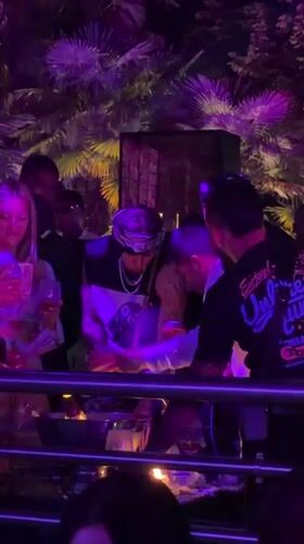 Milan outdoor club night glowing under purple and pink lights
