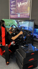 Man plays racing simulator at trade show in Bulgaria