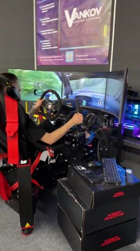 Man plays racing simulator at trade show in Bulgaria