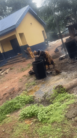 Woman works with barrels in outdoor area in Eke