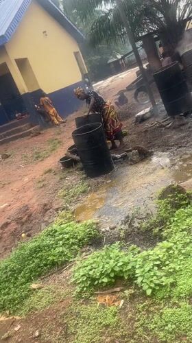 Woman works with barrels in outdoor area in Eke