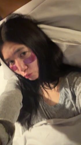 Woman documents skincare routine with eye patches in Essen