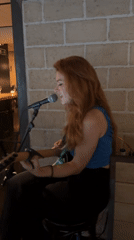 Live solo guitar performance in a Barcelona brick-wall venue