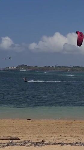 Kiteboarding session off Denpasar's coast on a sunny Bali morning