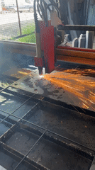 Plasma cutter slicing metal with sparks flying in Chicago