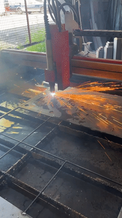 Plasma cutter slicing metal with sparks flying in Chicago