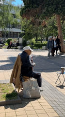 Accordion player performs in Lovech plaza amid scenic Bulgarian town views