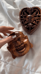 Person examines carved wooden objects in North Kuta Indonesia