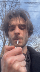 Man lights cigarette in Lobnya, Russia