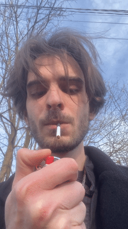 Man lights cigarette in Lobnya, Russia