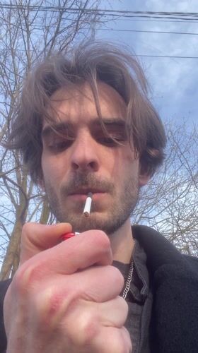 Man lights cigarette in Lobnya, Russia