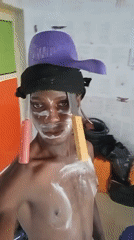 Street performer with white face paint documented in Akwete
