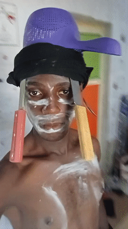 Street performer with white face paint documented in Akwete
