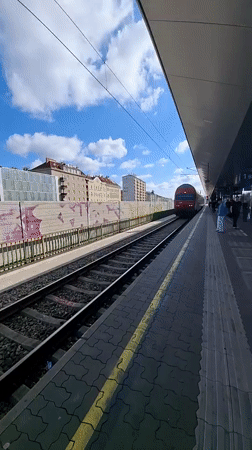 Morning commuter train arrives at Vienna station platform