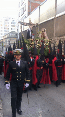 Religious procession with hooded participants moves through La Paz streets