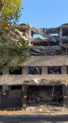 War-damaged buildings and a quiet park in Mykolaiv