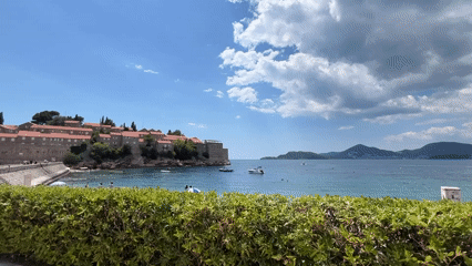 Tourists enjoy typical beach day at Sveti Stefan resort