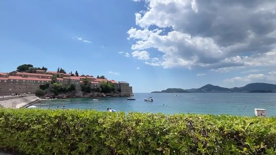 Tourists enjoy typical beach day at Sveti Stefan resort