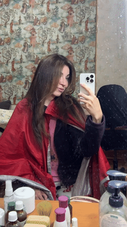 Woman takes selfies, relaxes indoors in Kryvyi Rih Sunday afternoon