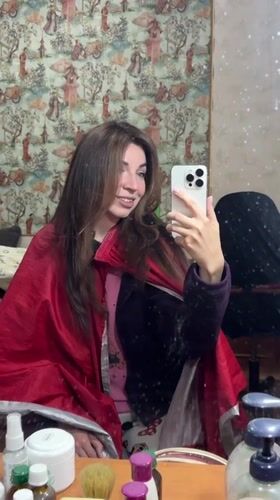 Woman takes selfies, relaxes indoors in Kryvyi Rih Sunday afternoon