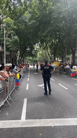 Crowds gather behind barriers on Barcelona street near Gothic building