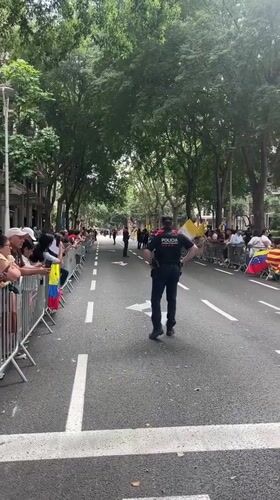 Crowds gather behind barriers on Barcelona street near Gothic building