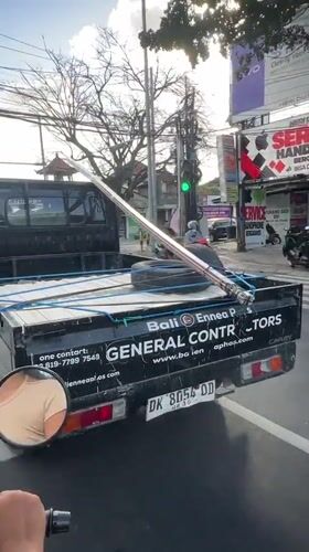 Morning traffic flow on a busy Denpasar street