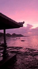 Sanur Beach at golden hour, gazebos and all