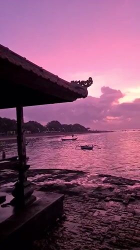 Sanur Beach at golden hour, gazebos and all