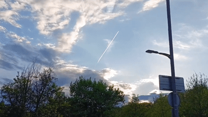 Ordinary moments captured in Yerevan: sky contrail, pedestrian