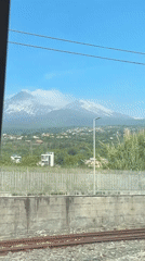 Train passenger records window view of residential area
