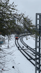 Train approaches on snowy tracks in Khimki, Russia