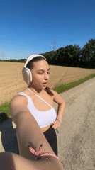Woman records selfie videos on rural path in Viersen